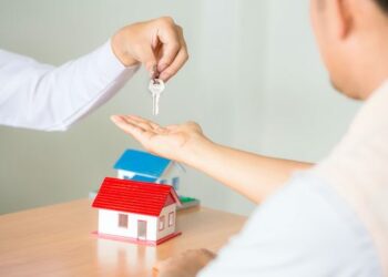 A Person Receiving Single Family Home Key For Multiple Families Live Concept